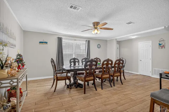 a kitchen with stainless steel appliances kitchen island granite countertop a refrigerator and a stove top oven