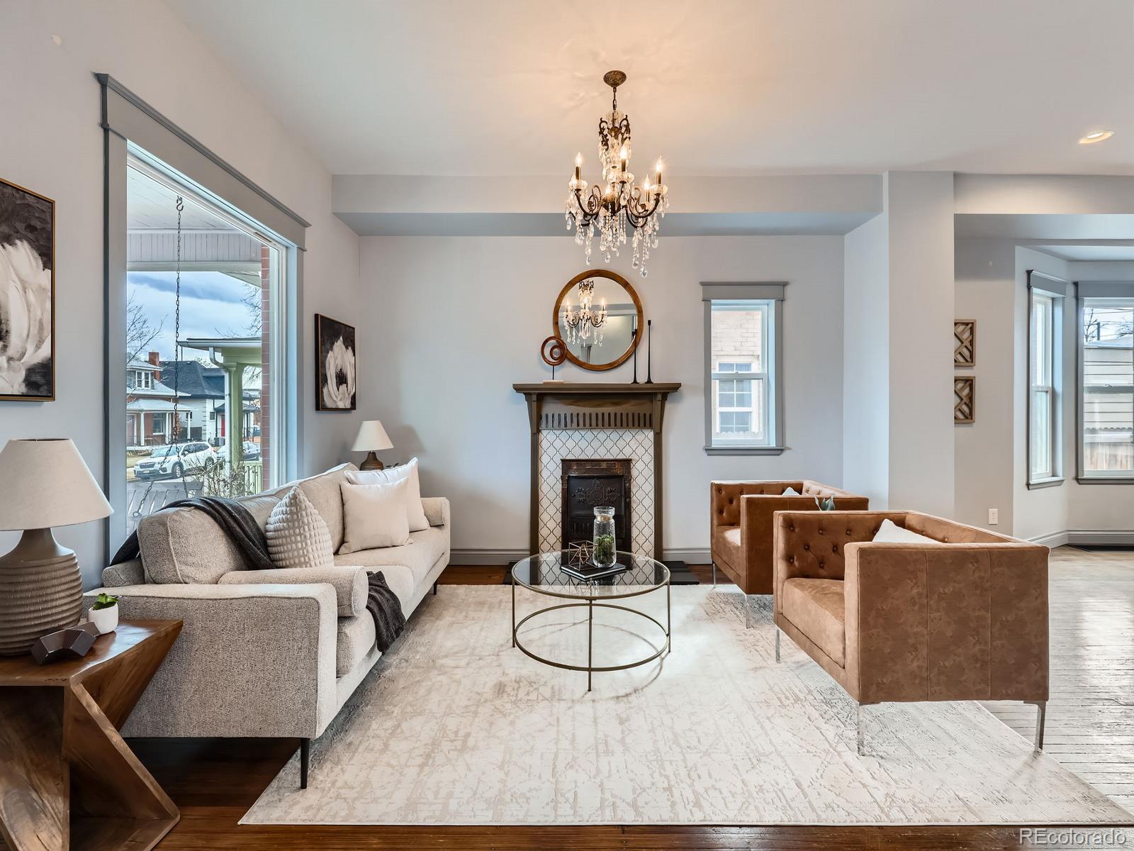 3833 Umatilla Street Denver, CO 80211 - Photo 12 of 50 a living room with furniture a fireplace and a chandelier