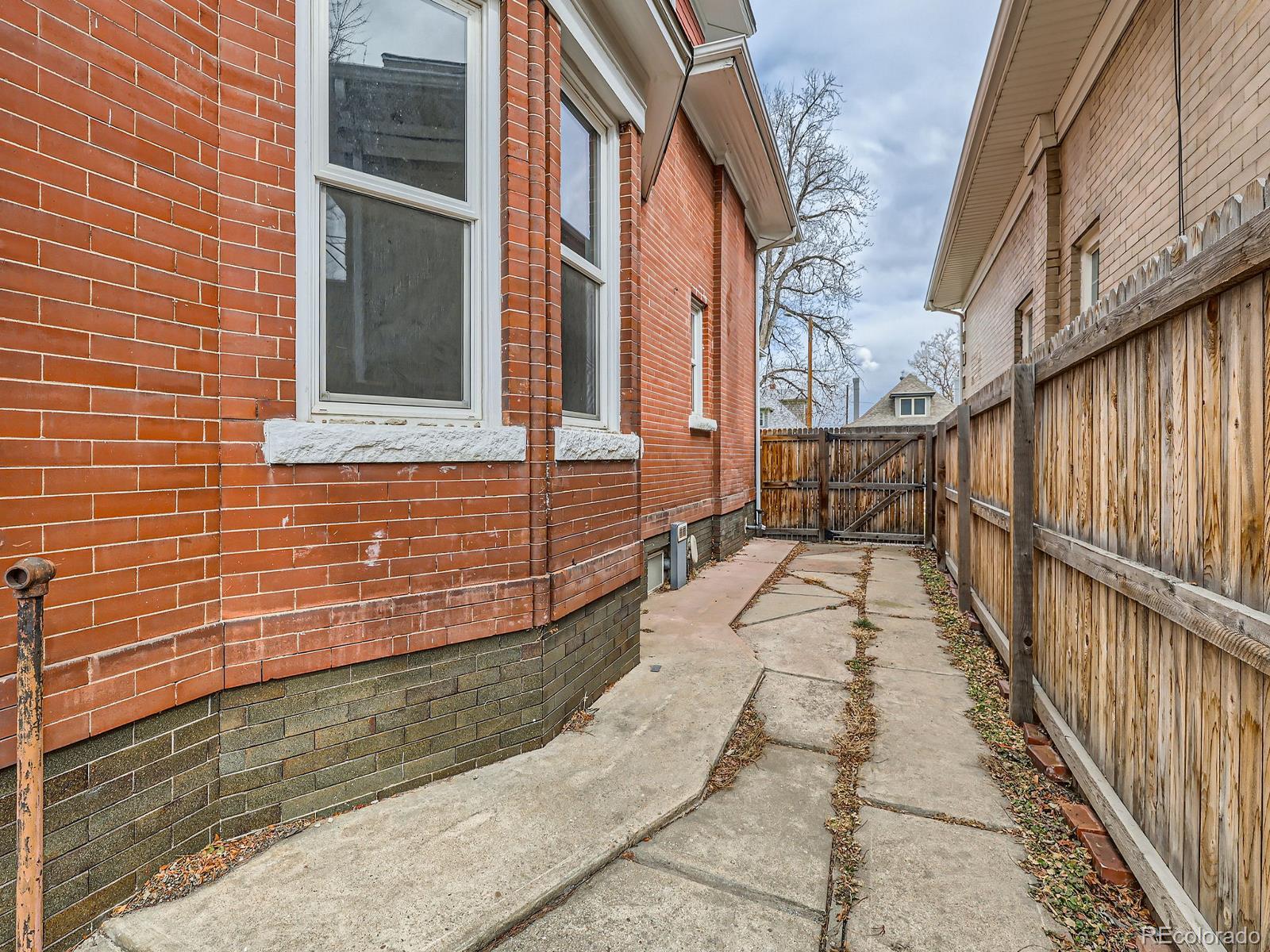 3833 Umatilla Street Denver, CO 80211 - Photo 50 of 50 a view of a brick house with a large window