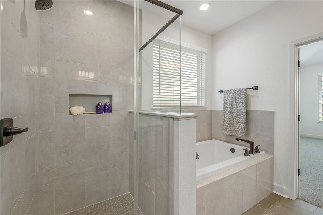 5010 Acadia Loop Bryan, TX 77802 - Photo 19 of 21 a bathroom with a bathtub and a shower