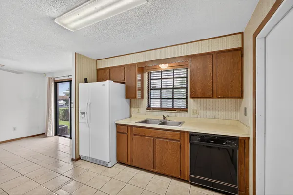 a kitchen with a stove sink and cabinets