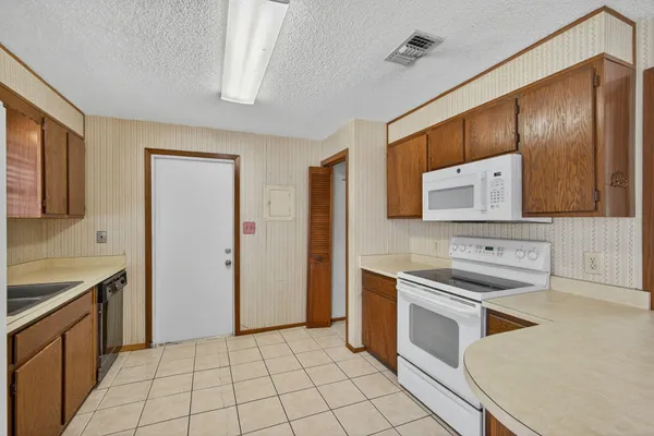 a view of kitchen with furniture and wooden floor