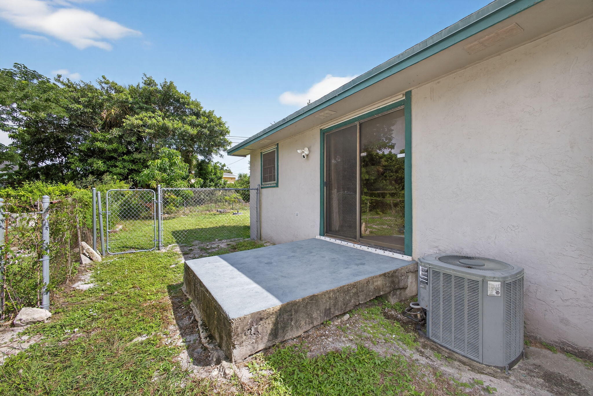 1332 West 33rd Street Riviera Beach, FL 33404 - Photo 21 of 25 a view of backyard with barbeque grill and outdoor seating