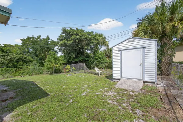 a view of backyard with a garden and deck