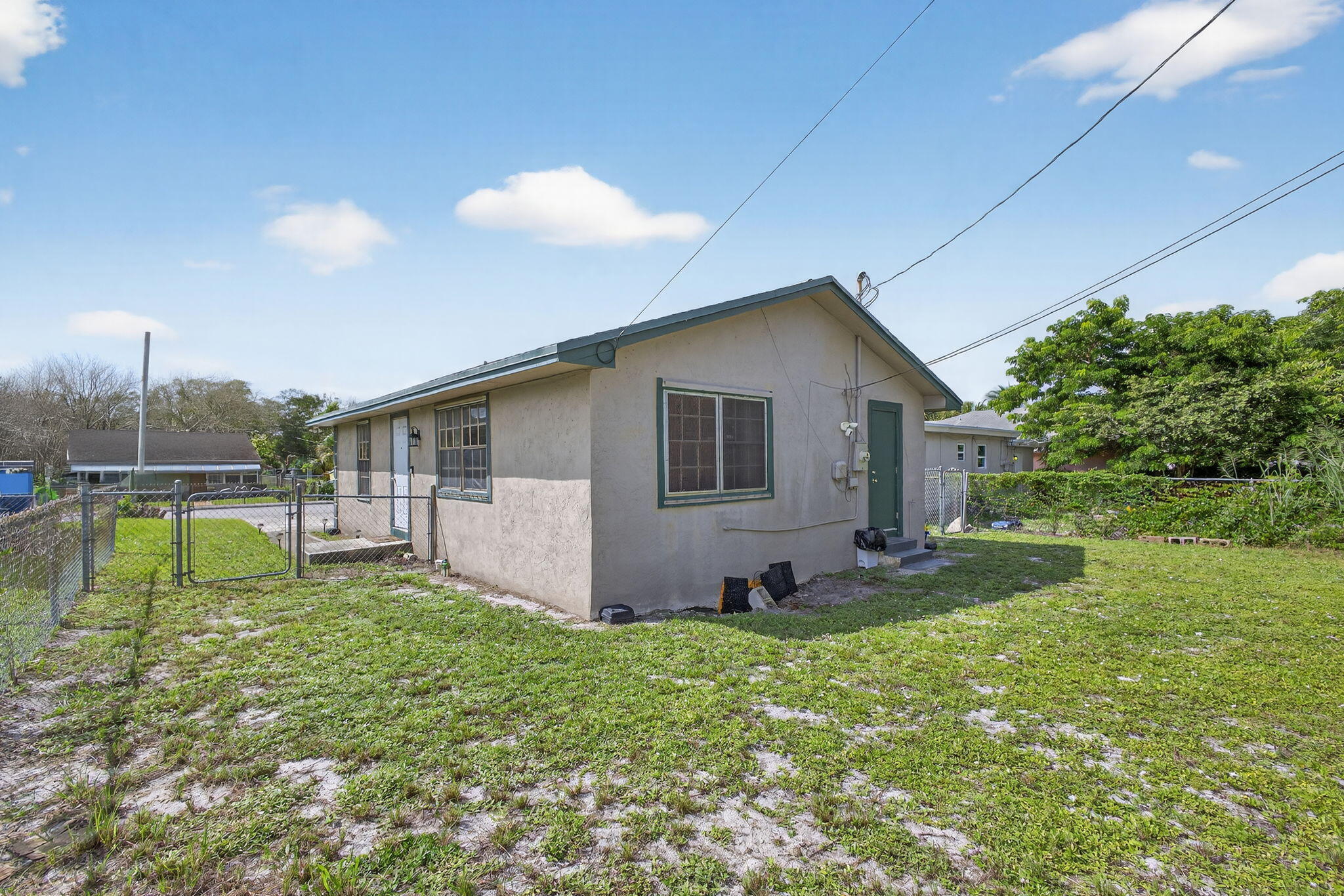 1332 West 33rd Street Riviera Beach, FL 33404 - Photo 24 of 25 a view of backyard with a garden and deck