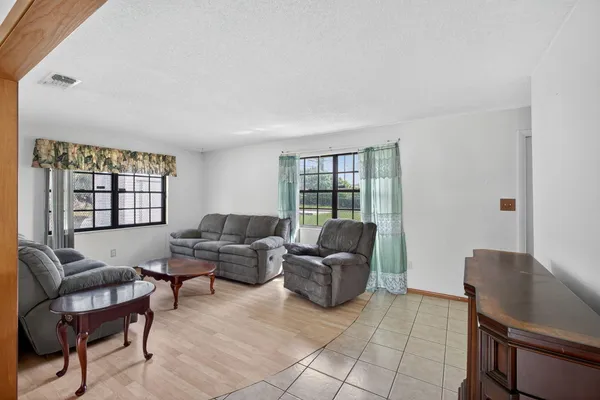 a living room with furniture a couch and a window