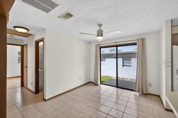 a view of a livingroom with furniture and a ceiling fan
