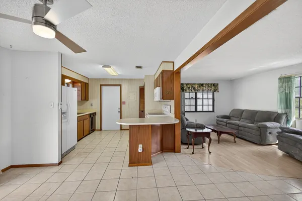 a kitchen with stainless steel appliances granite countertop a refrigerator and a sink