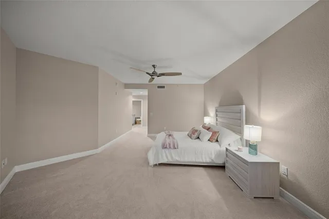 a bedroom with a bed and a lamp