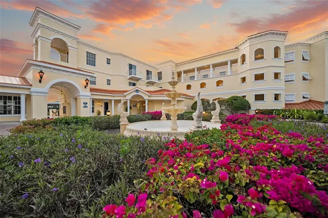 a view of building with an flowers and house