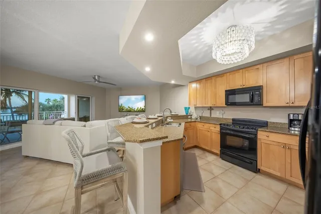 a kitchen with a stove a sink and a refrigerator