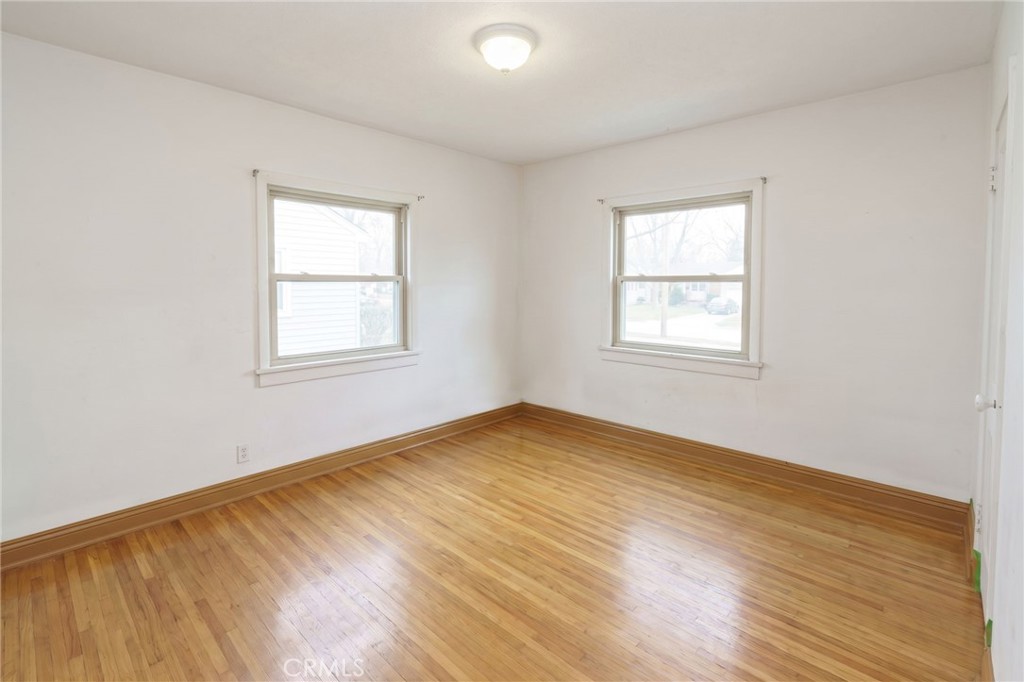 346 West School Street Compton, CA 90220 - Photo 18 of 29 an empty room with wooden floor and windows