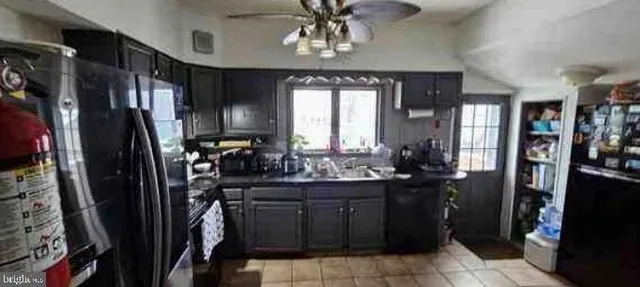a kitchen with a refrigerator and a sink