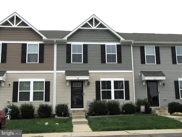 a front view of a house with a yard and porch