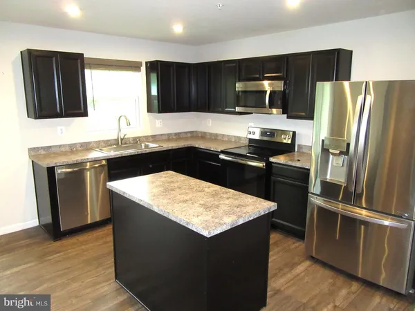 a kitchen with a sink stove and refrigerator