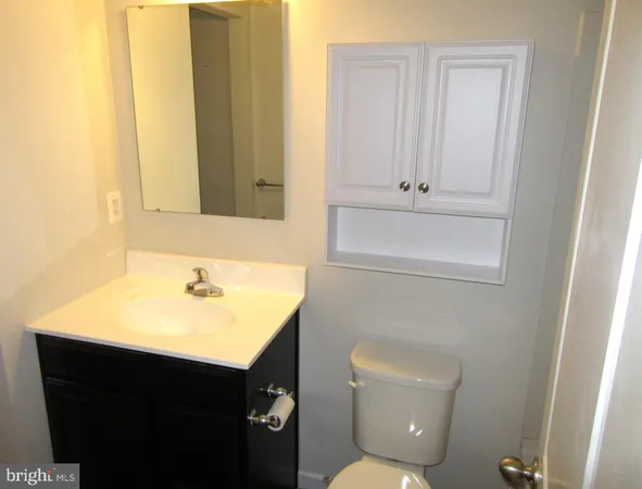 a bathroom with a sink toilet and vanity