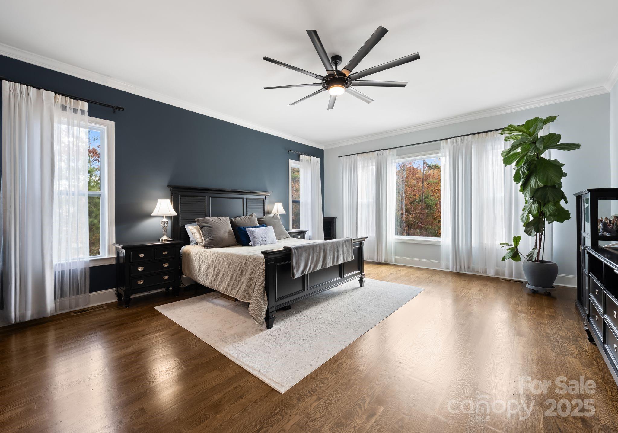 16312 Cozy Cove Road Charlotte, NC 28278 - Photo 16 of 48 a spacious bedroom with a bed a couch and a large window