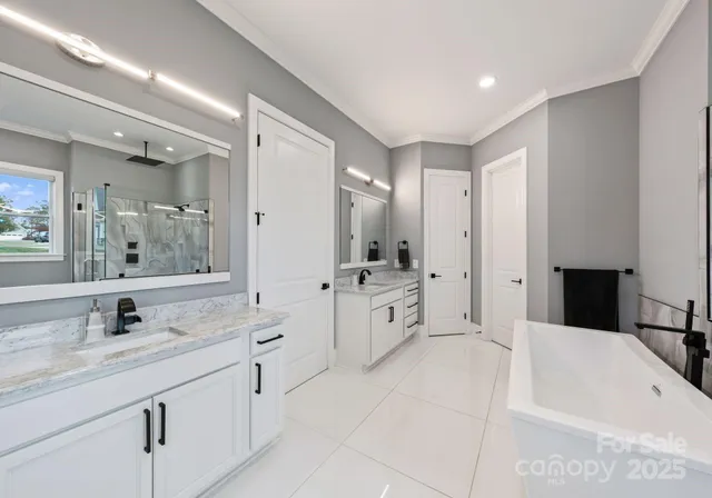 a bathroom with a granite countertop sink mirror and a bathtub