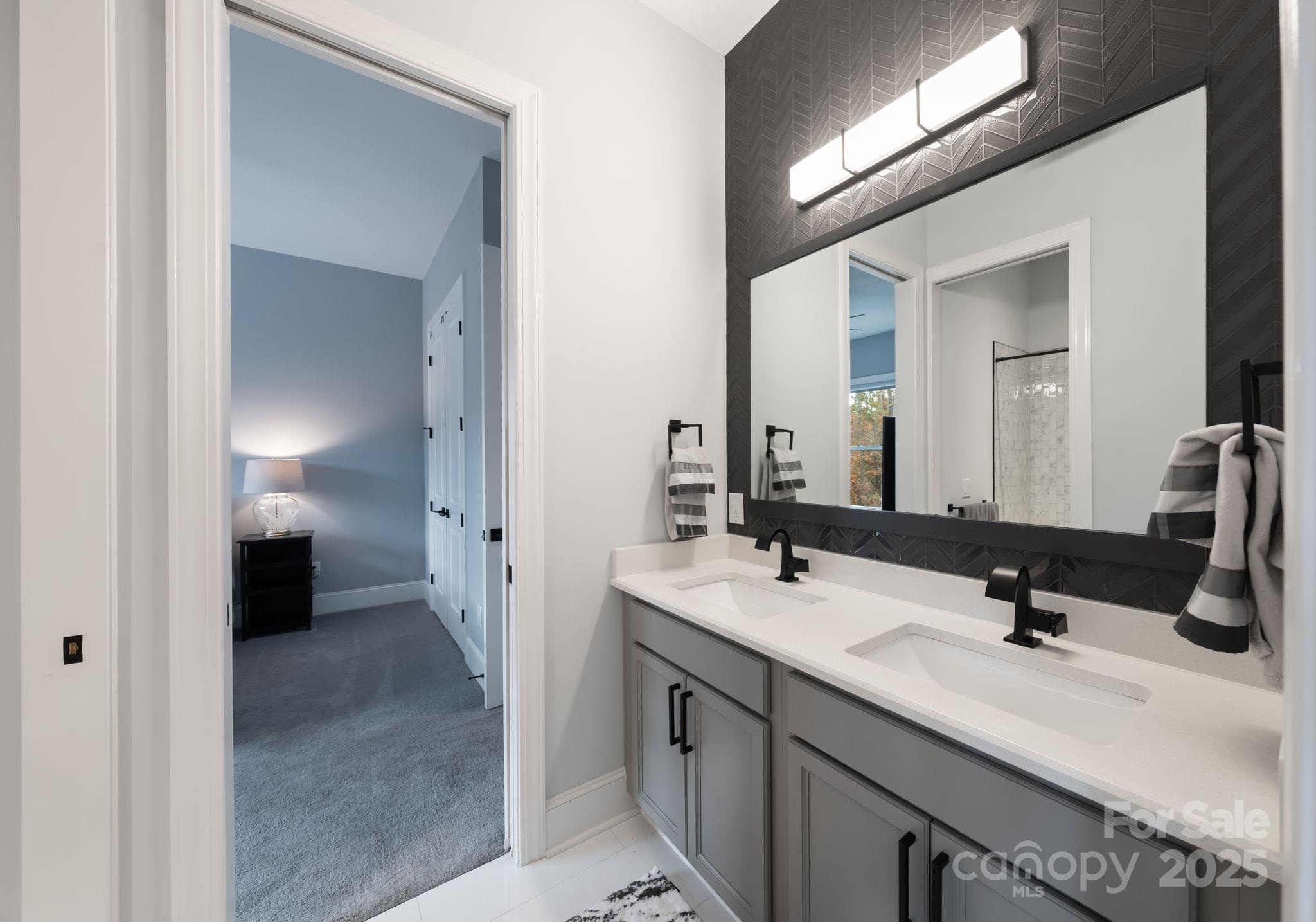 16312 Cozy Cove Road Charlotte, NC 28278 - Photo 21 of 48 a en suite bathroom with a double vanity sink and a mirror