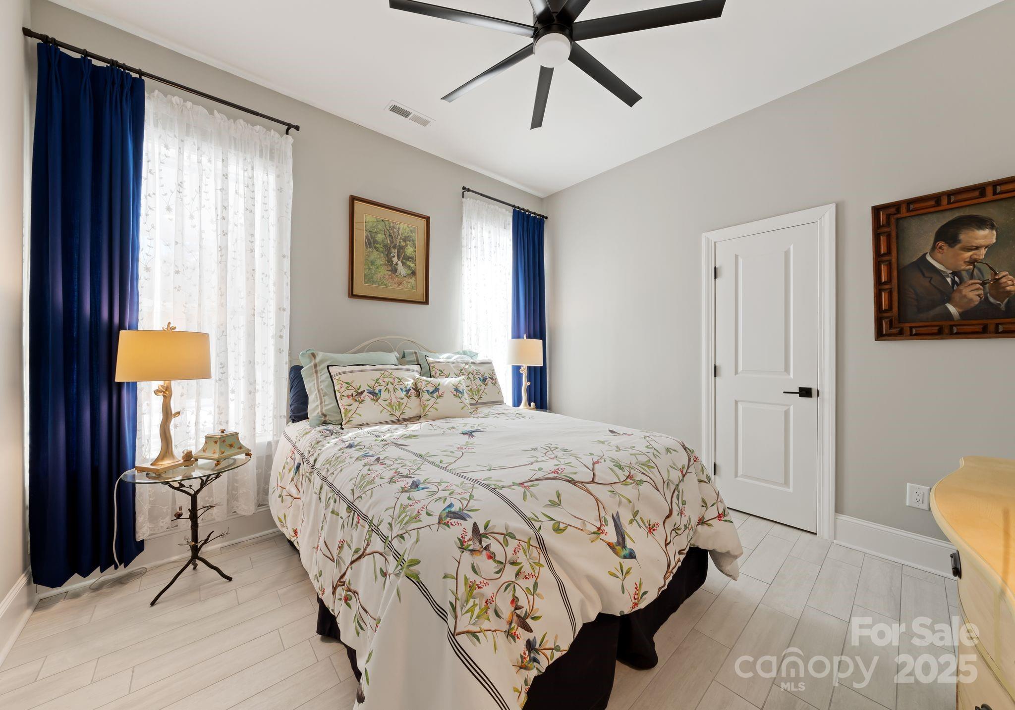 16312 Cozy Cove Road Charlotte, NC 28278 - Photo 33 of 48 a bedroom with a bed and a painting on the wall