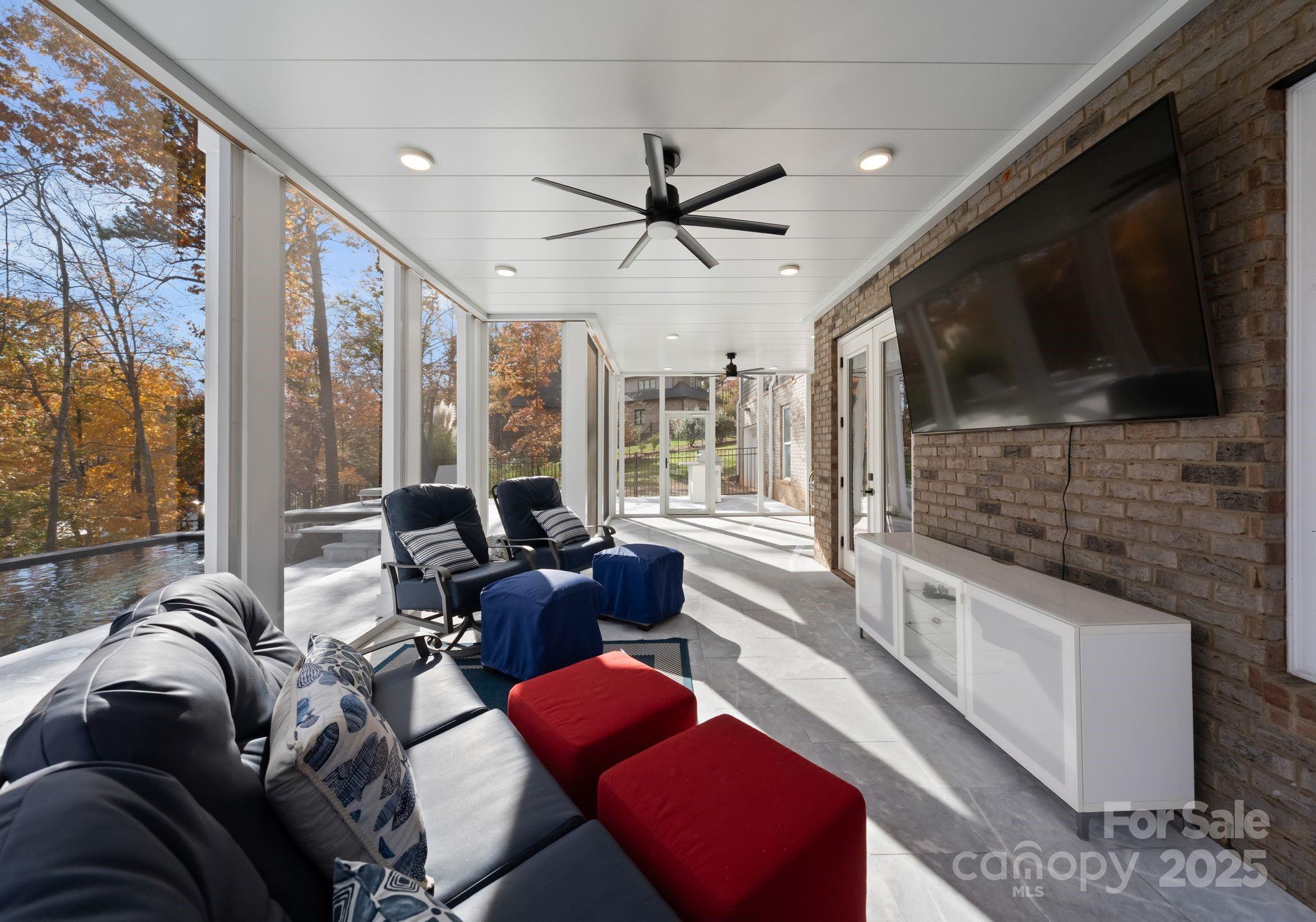 16312 Cozy Cove Road Charlotte, NC 28278 - Photo 37 of 48 a living room with furniture a flat screen tv and a large window