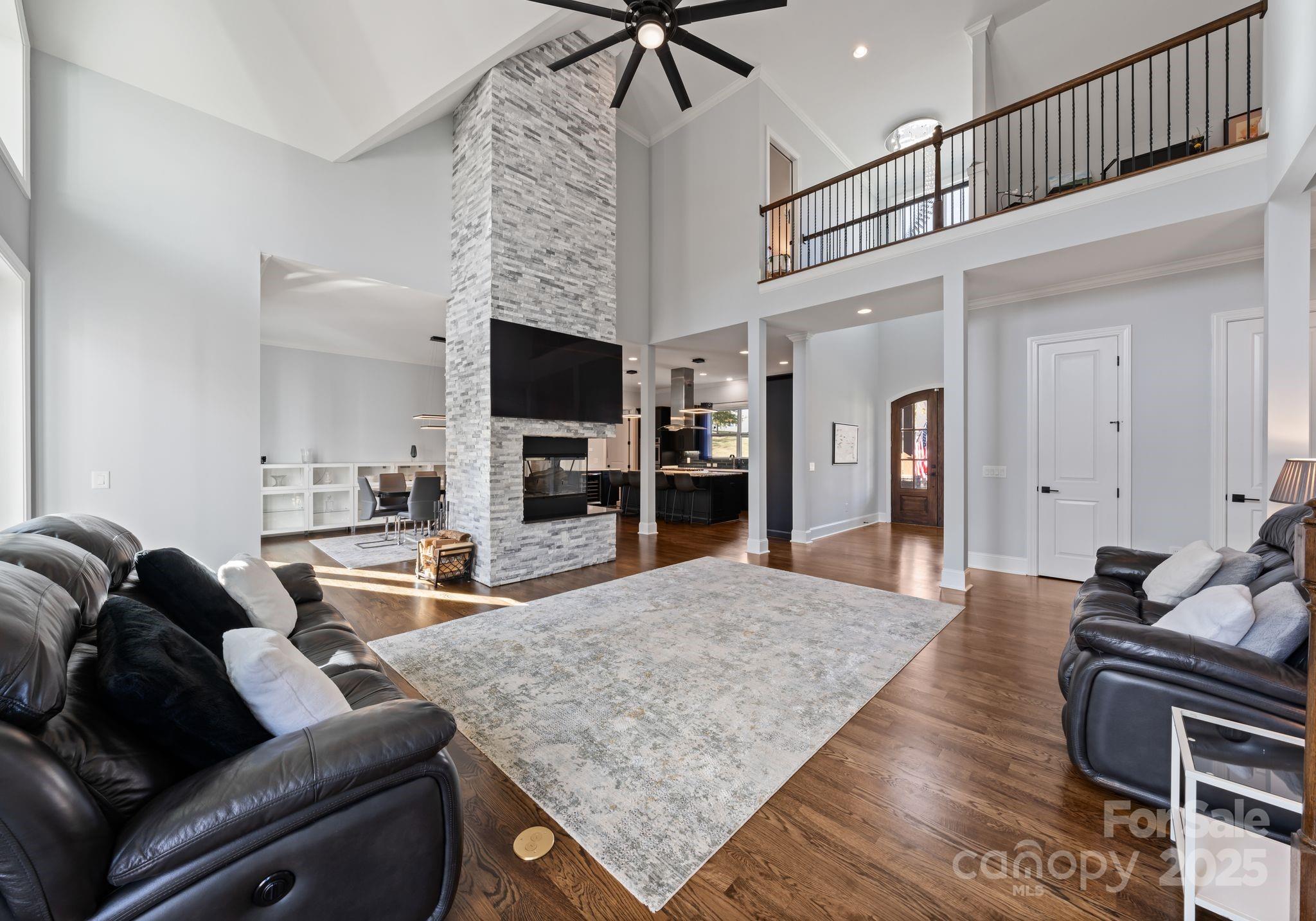 16312 Cozy Cove Road Charlotte, NC 28278 - Photo 7 of 48 a living room with furniture and a flat screen tv