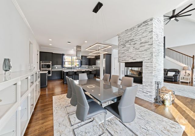 a living room with fireplace furniture and a wooden floor