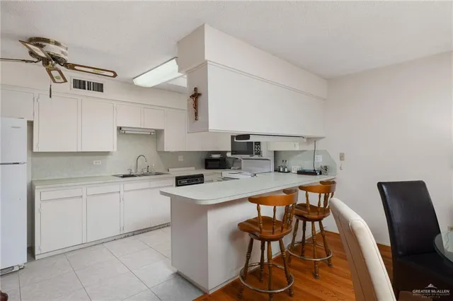 a kitchen that has a table and chairs in it