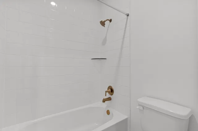 a bathroom with a bathtub and a toilet