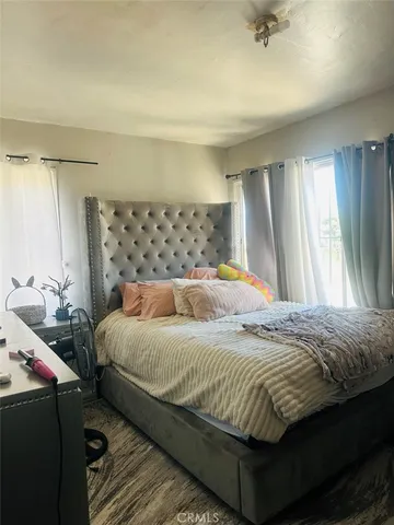 a bedroom with a bed and window