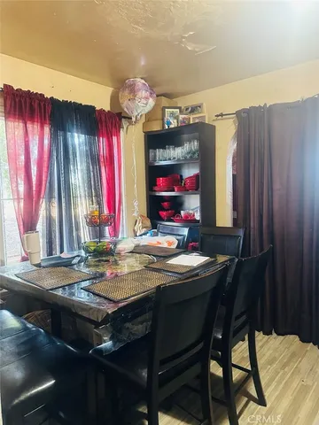 a view of a dining room with furniture and window
