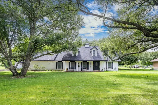 a front view of house with yard and green space
