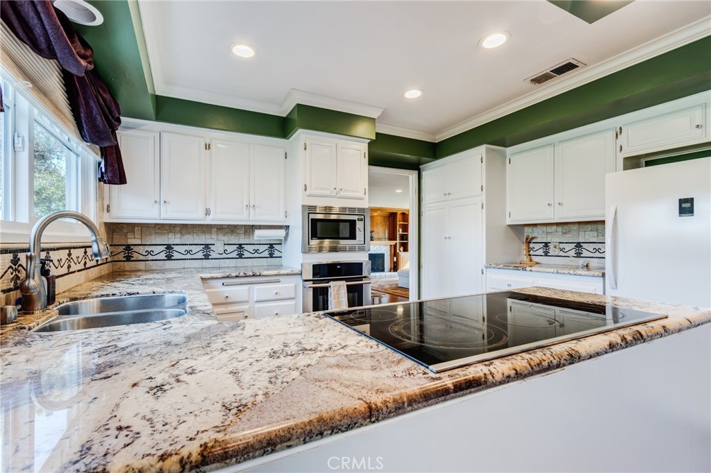 2757 Puente Street Fullerton, CA 92835 - Photo 20 of 71 a kitchen with stainless steel appliances granite countertop a sink a stove and a refrigerator