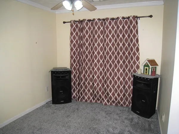 a bedroom with a bed and a flat tv screen on dresser