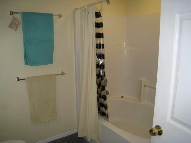 a bathroom with bathtub and shower