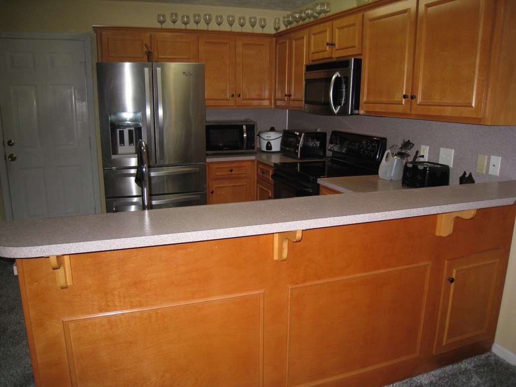 3007 Alamo Court Columbus, GA 31907 - Photo 4 of 24 a kitchen with stainless steel appliances a refrigerator a sink a stove top oven and cabinets