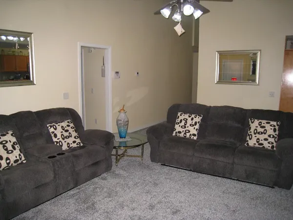 a living room with furniture and a chandelier