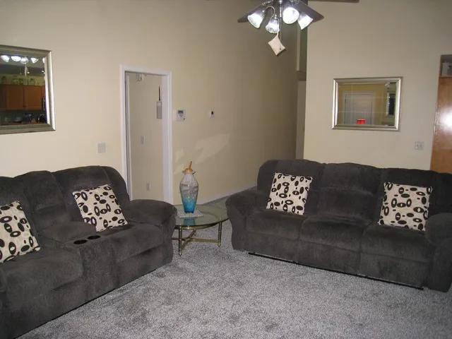 a living room with furniture and a chandelier