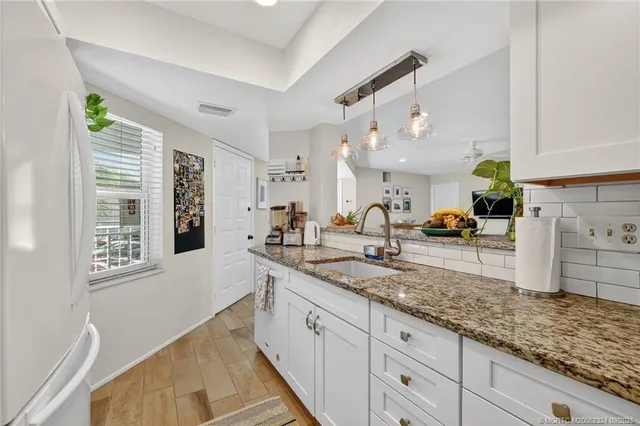 a kitchen with a refrigerator sink and stove