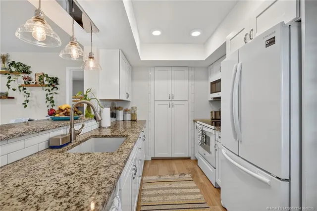 a kitchen with a refrigerator and a stove top oven