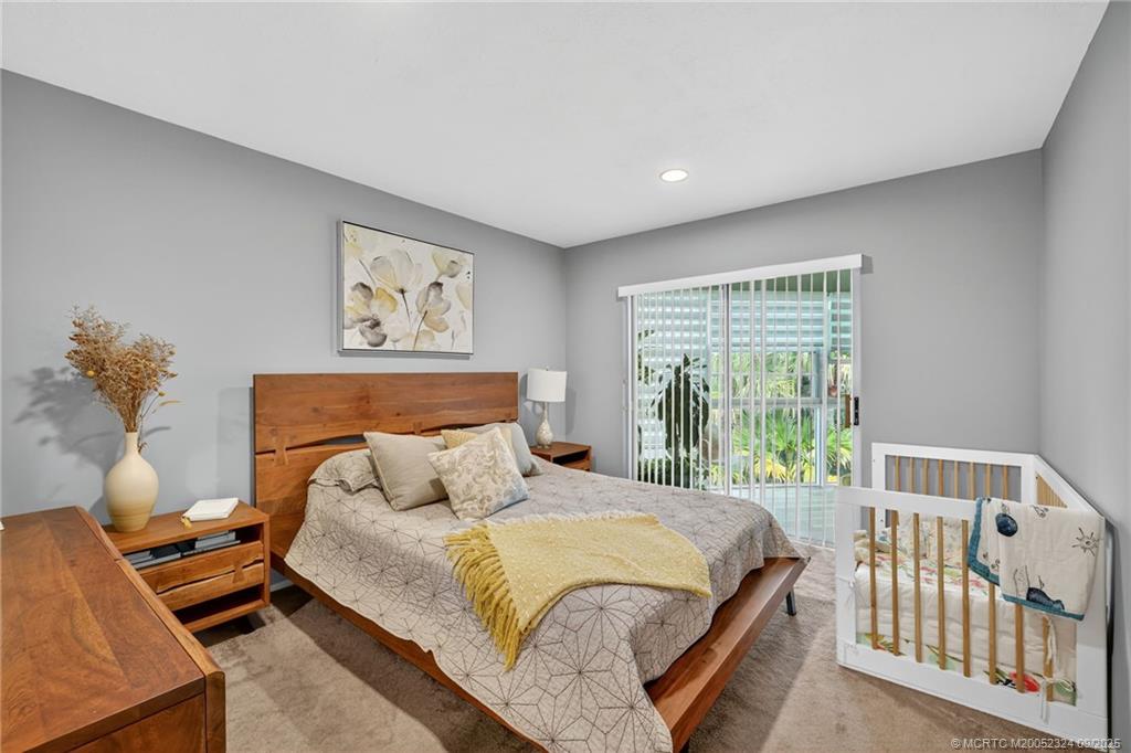 3260 Southeast Aster Lane, Unit I241 Stuart, FL 34994 - Photo 17 of 48 a bedroom with a bed and a window