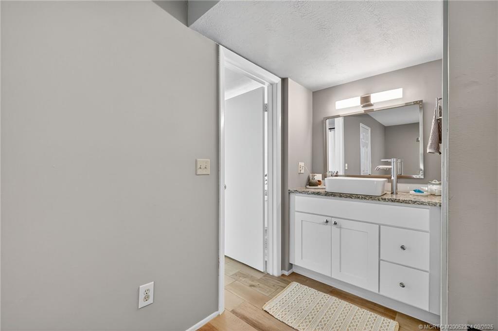 3260 Southeast Aster Lane, Unit I241 Stuart, FL 34994 - Photo 19 of 48 a bathroom with a double vanity sink and mirror