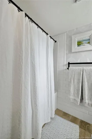 a bathroom with a shower and a curtain