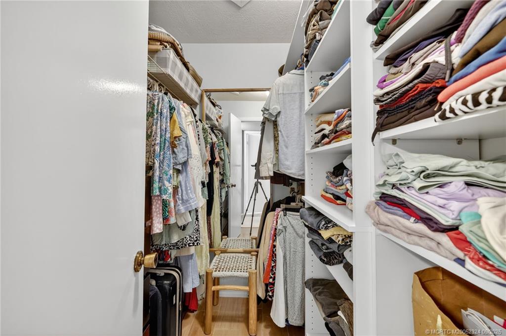 3260 Southeast Aster Lane, Unit I241 Stuart, FL 34994 - Photo 22 of 48 a view of walk in closet with clothes and shoes
