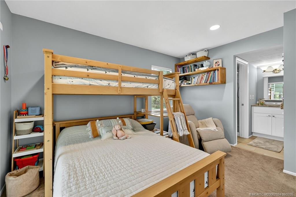 3260 Southeast Aster Lane, Unit I241 Stuart, FL 34994 - Photo 24 of 48 a bedroom with a bed and a cabinets