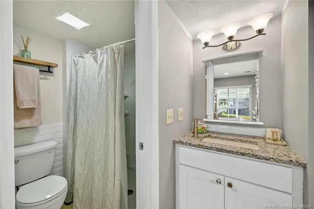 a bathroom with a shower toilet and sink