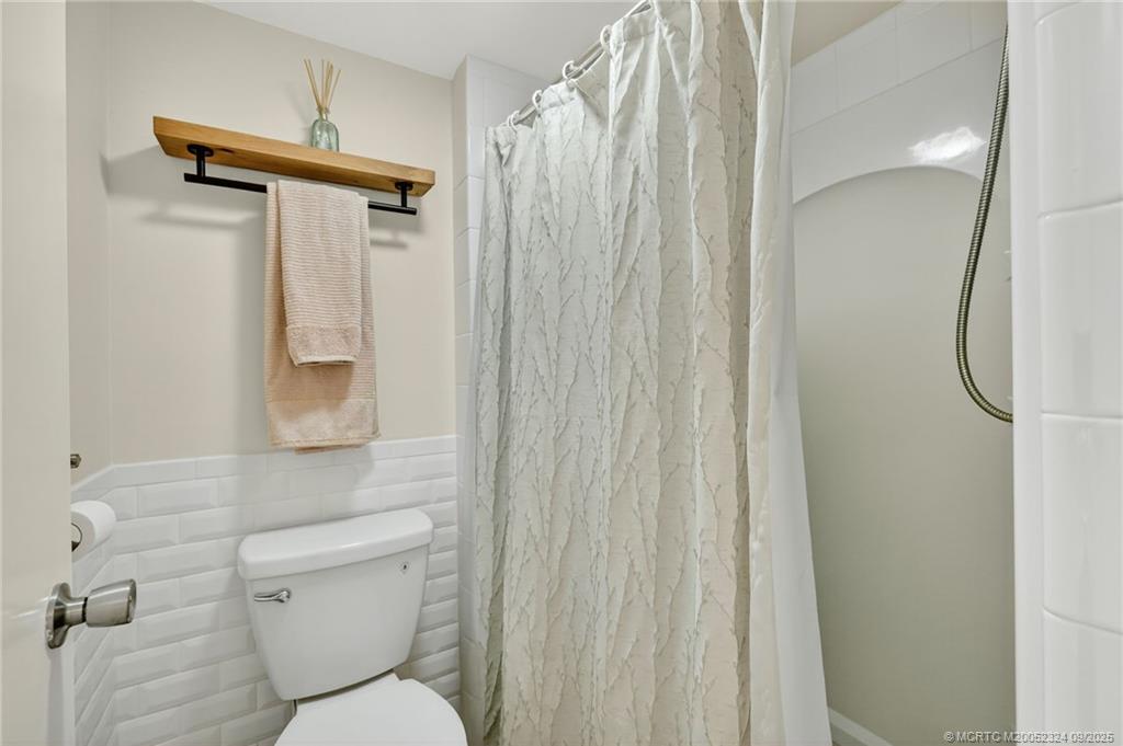 3260 Southeast Aster Lane, Unit I241 Stuart, FL 34994 - Photo 28 of 48 a bathroom with a shower toilet and sink