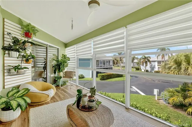 a living room with furniture and a floor to ceiling window