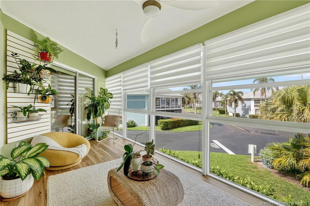 3260 Southeast Aster Lane, Unit I241 Stuart, FL 34994 - Photo 33 of 48 a living room with patio furniture and a potted plant