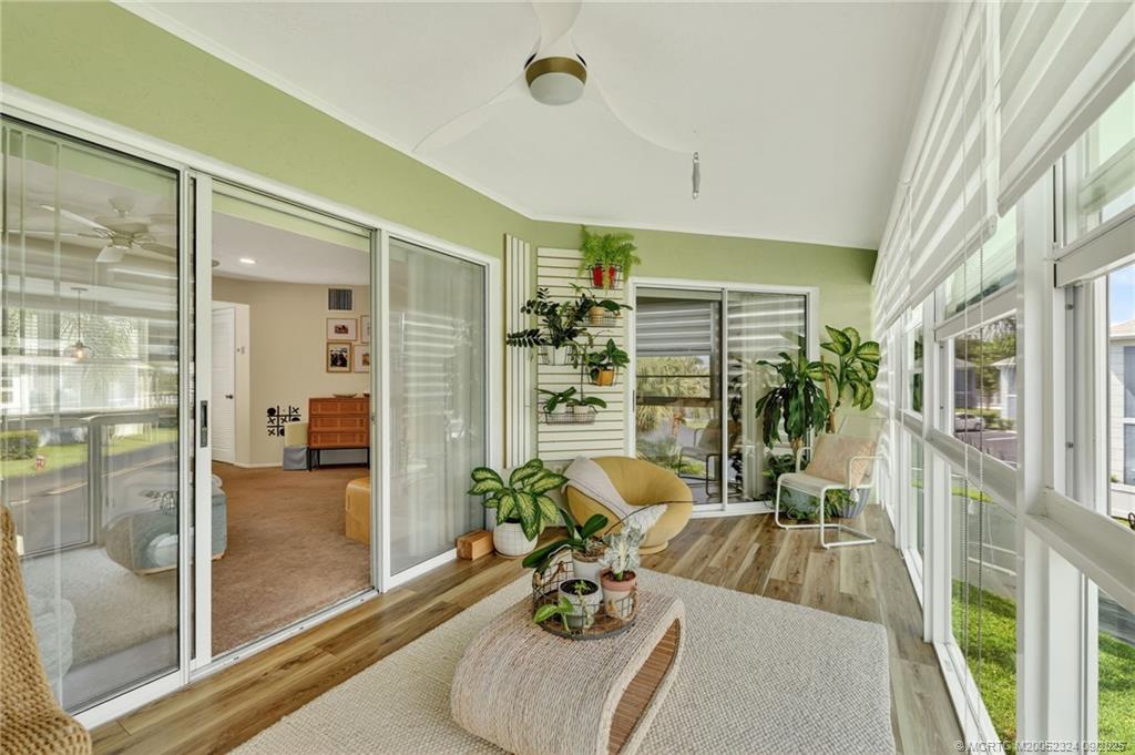 3260 Southeast Aster Lane, Unit I241 Stuart, FL 34994 - Photo 35 of 48 a living room with furniture and a floor to ceiling window